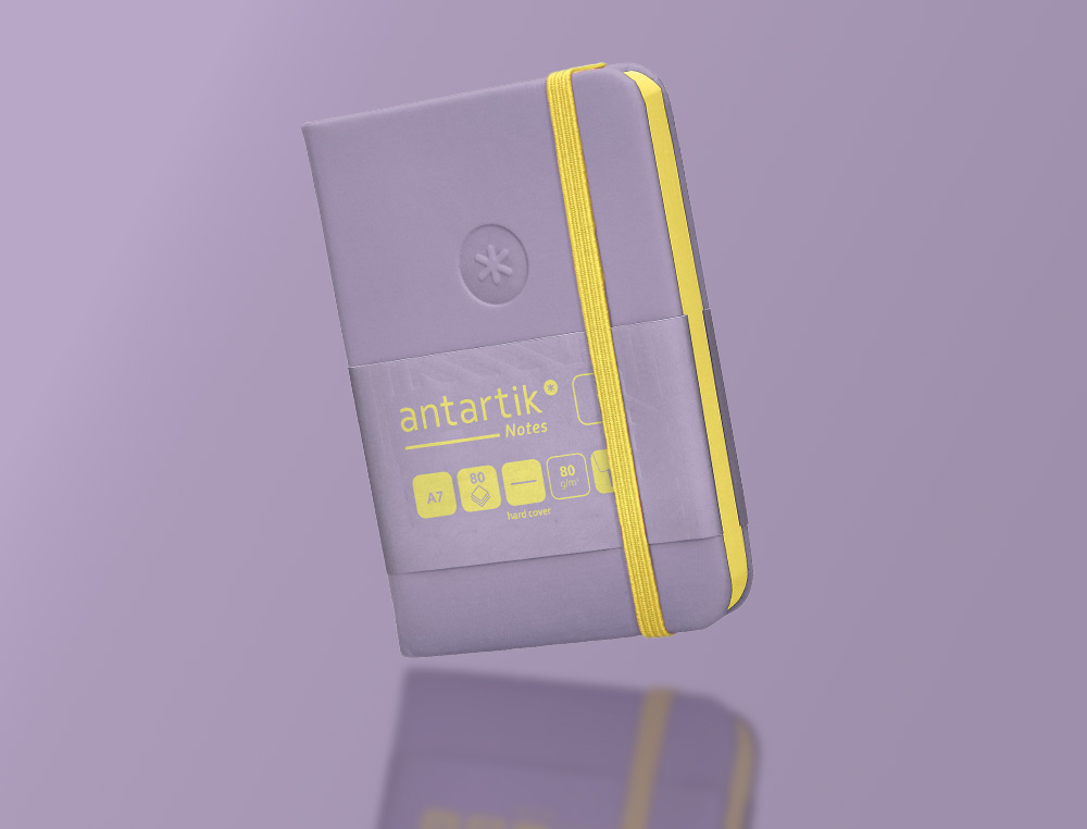 CARNET A7 ANTARTIK NOTES PAPIER UNI IVOIRE COUVERTURE RIGIDE FERMETURE ELASTIQUE JAUNE 80 PAGES 80GR COLORIS LILAS